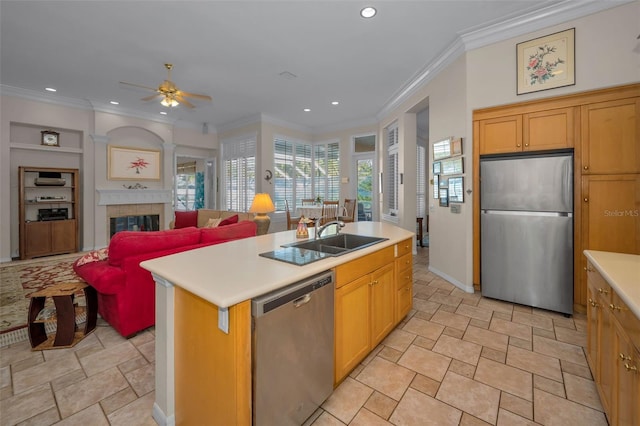 kitchen featuring a ceiling fan, a sink, stainless steel appliances, light countertops, and crown molding