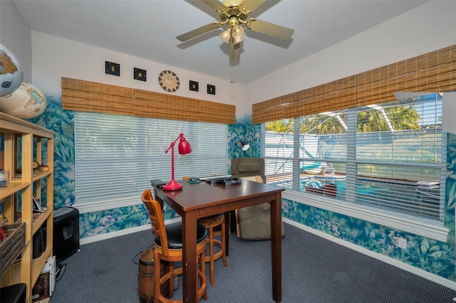 carpeted home office featuring baseboards and a ceiling fan