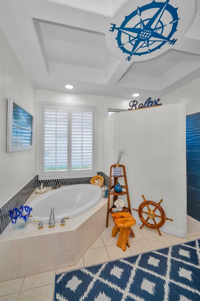 bathroom with tile patterned flooring, a bath, and a raised ceiling