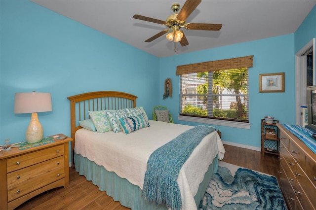 bedroom with wood finished floors, baseboards, and ceiling fan