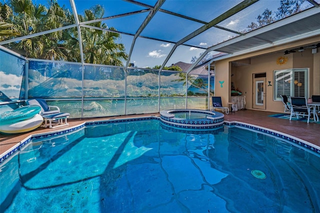 view of swimming pool featuring a patio area, glass enclosure, a pool with connected hot tub, and a ceiling fan