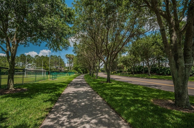 surrounding community with a yard and fence