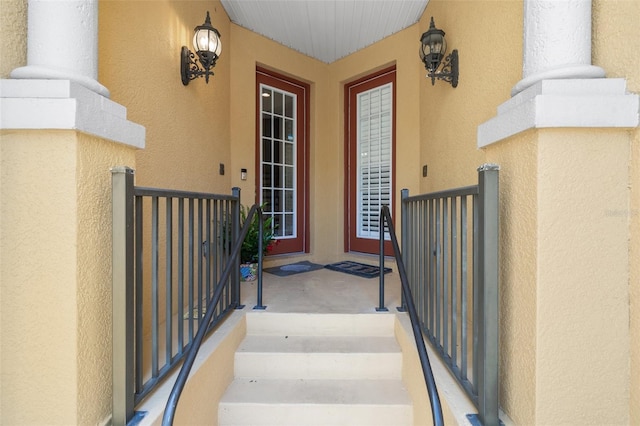 entrance to property with stucco siding