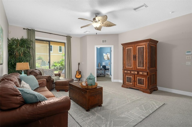 living area featuring visible vents, light carpet, and baseboards