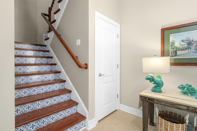 stairway featuring tile patterned flooring and baseboards