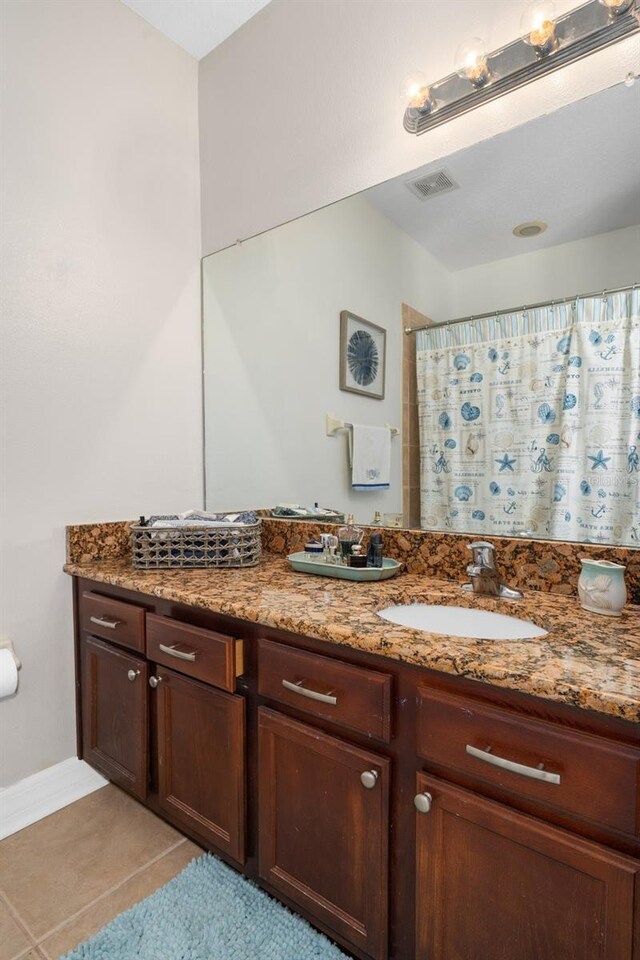 bathroom with a shower with curtain, vanity, visible vents, and tile patterned floors