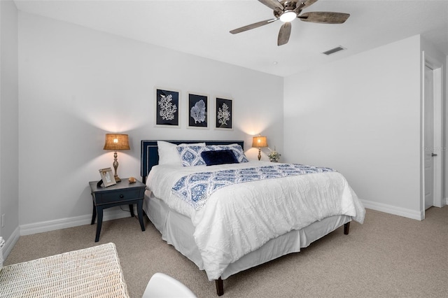 bedroom featuring baseboards, ceiling fan, visible vents, and light colored carpet