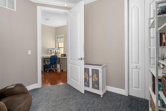 office with baseboards, visible vents, and dark colored carpet