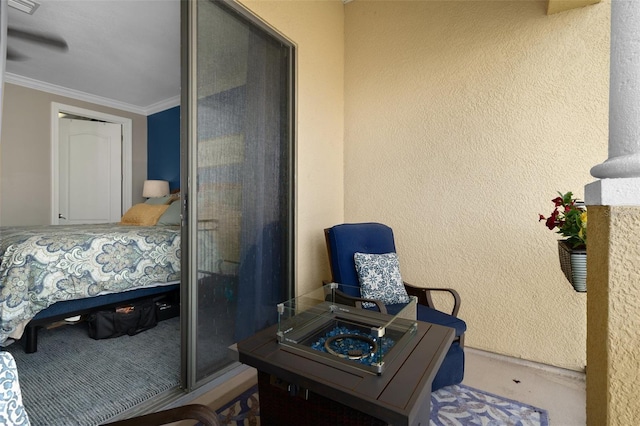 bedroom with a textured wall, ornamental molding, and a closet