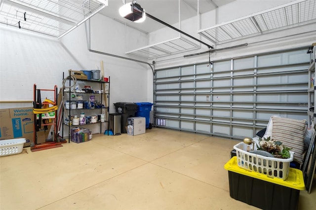 garage with concrete block wall and a garage door opener