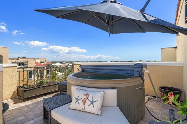 view of patio / terrace with a hot tub