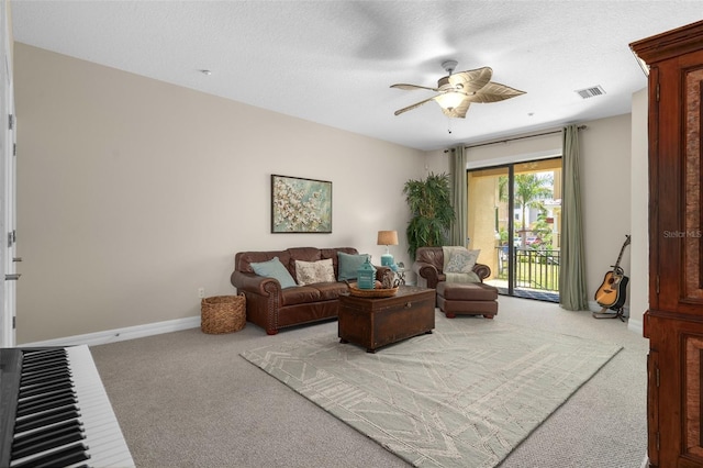 6411 Mayra Shores Ln, Apollo Beach, FL 33572 - living area featuring carpet flooring, ceiling fan, baseboards, and a textured ceiling