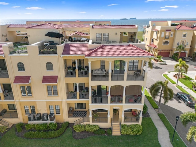 6411 Mayra Shores Ln, Apollo Beach, FL 33572 - view of apartment building / complex featuring driveway, an attached garage, and a water view
