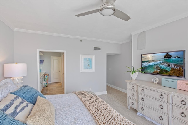 bedroom with light wood-style floors, baseboards, visible vents, and ornamental molding