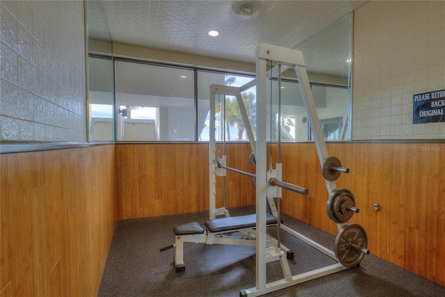 workout area featuring wood walls