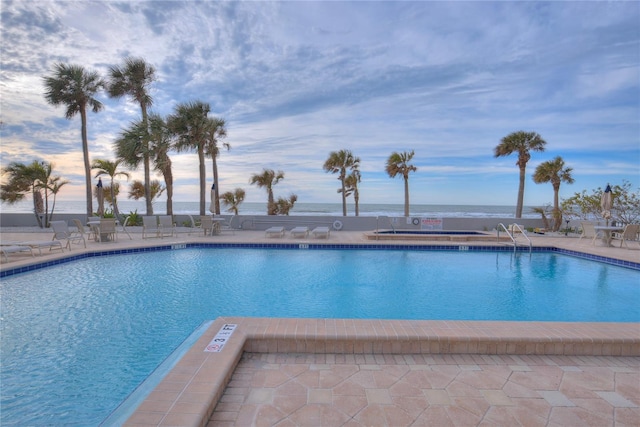 community pool with a patio area