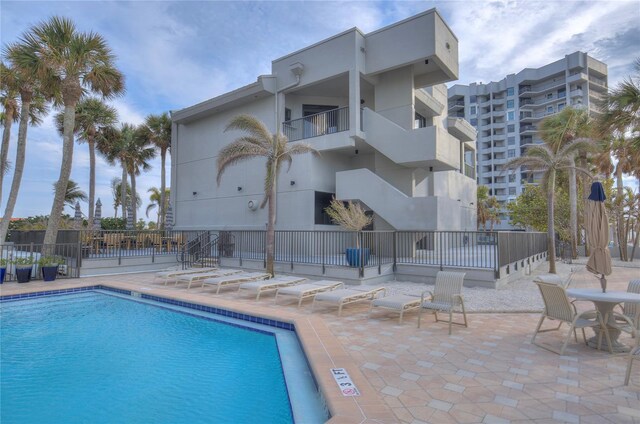 pool featuring a patio area and fence