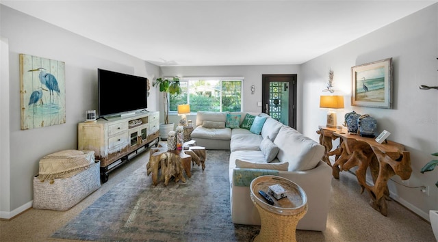 living area featuring baseboards