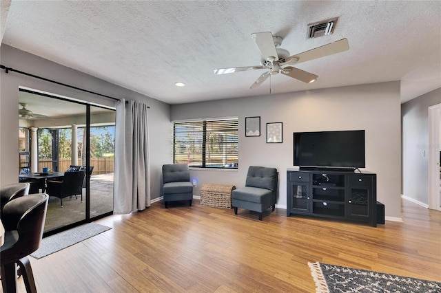 811 Eagle Ln, Apollo Beach, FL 33572 - living area with a ceiling fan, a textured ceiling, wood finished floors, plenty of natural light, and recessed lighting