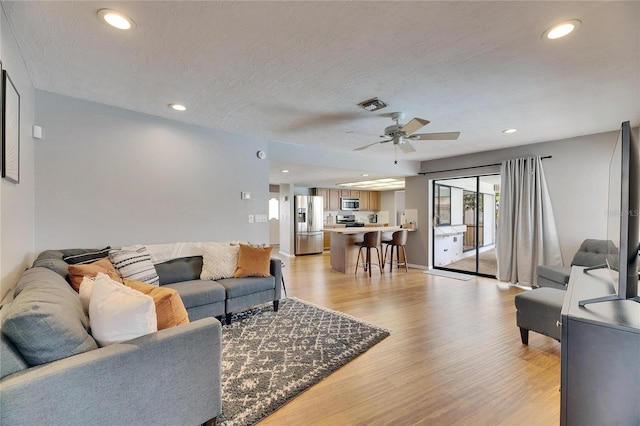 811 Eagle Ln, Apollo Beach, FL 33572 - living area with a ceiling fan, light wood-style floors, a textured ceiling, and recessed lighting