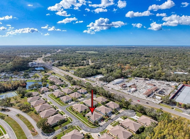 drone / aerial view featuring a residential view and a water view