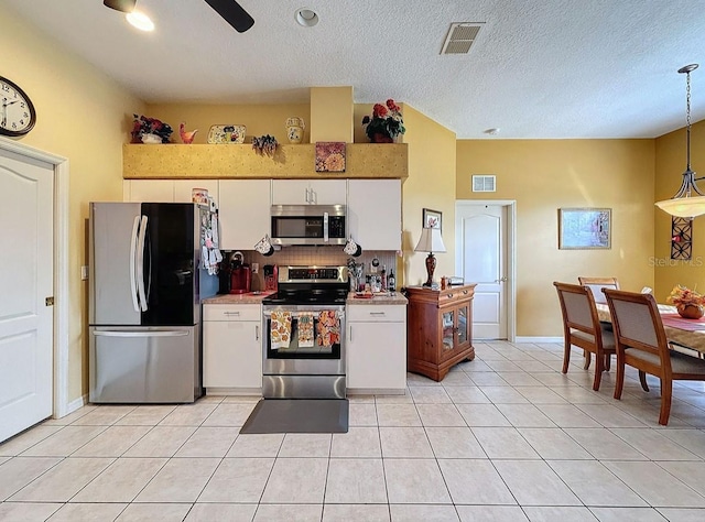 kitchen with white cabinetry, light tile patterned flooring, visible vents, and stainless steel appliances