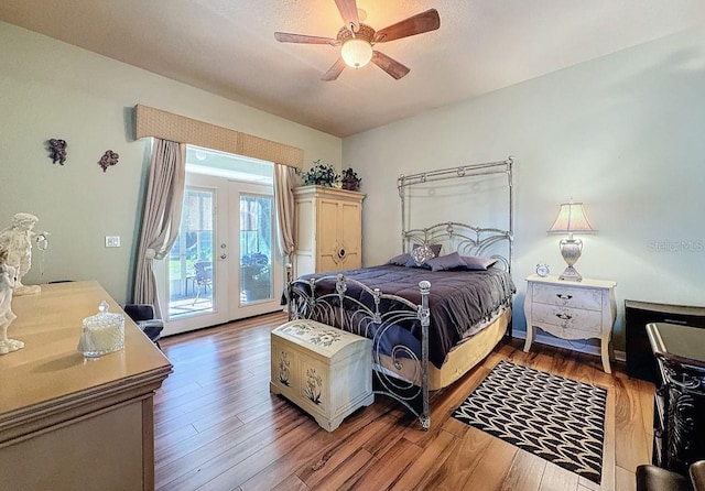 bedroom with access to exterior, french doors, a ceiling fan, and wood finished floors