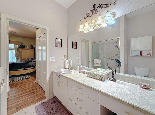 full bathroom with vanity, a shower stall, ensuite bathroom, tile patterned floors, and toilet