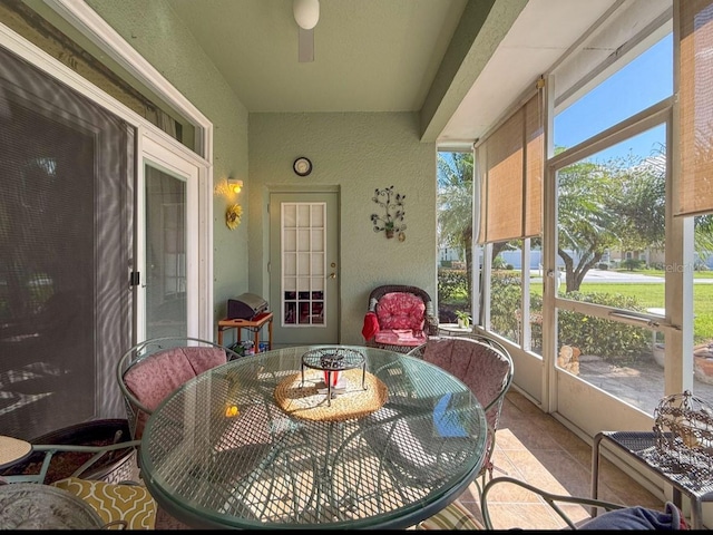 sunroom / solarium with a healthy amount of sunlight and a ceiling fan