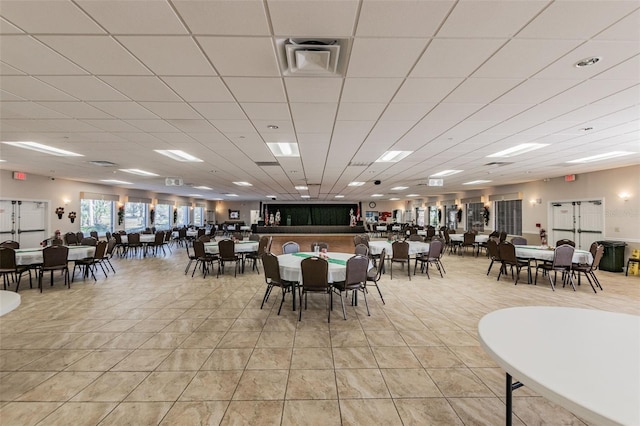 dining space featuring light tile patterned floors, visible vents, and a paneled ceiling