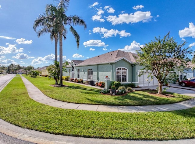 view of front of house with stucco siding, a front lawn, an attached garage, and driveway