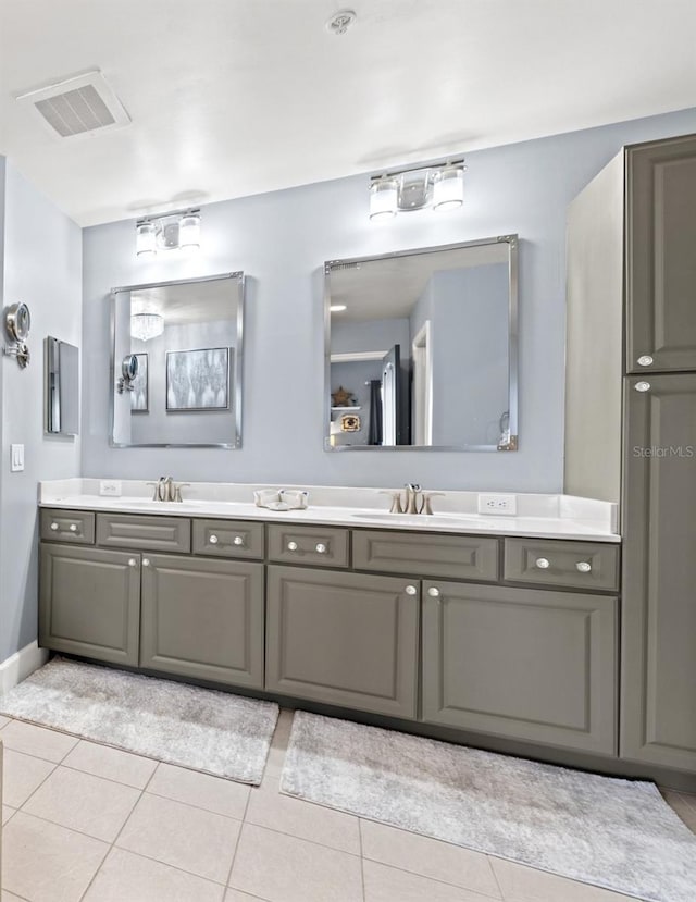 full bathroom with double vanity, visible vents, and a sink
