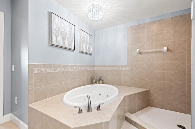 full bathroom with baseboards and a whirlpool tub