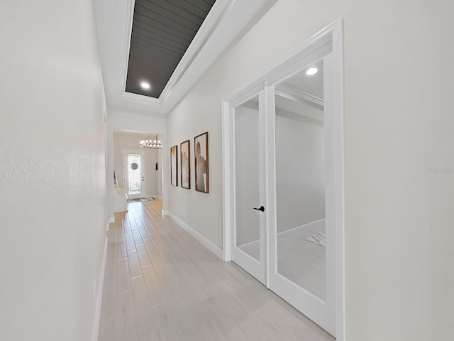 corridor with recessed lighting, light wood-style flooring, and baseboards