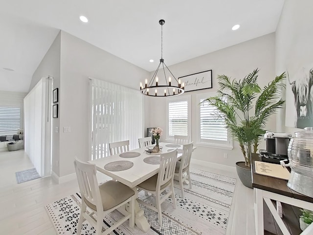 dining space with baseboards, an inviting chandelier, and recessed lighting