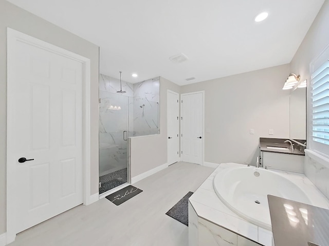 full bathroom featuring a marble finish shower, baseboards, a garden tub, vanity, and recessed lighting