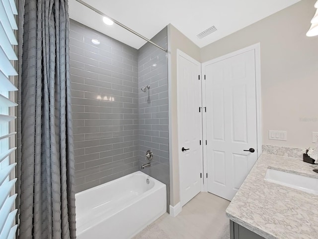 bathroom featuring vanity, shower / bath combo with shower curtain, and visible vents