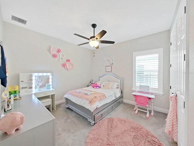 bedroom with light carpet, baseboards, visible vents, a ceiling fan, and a closet