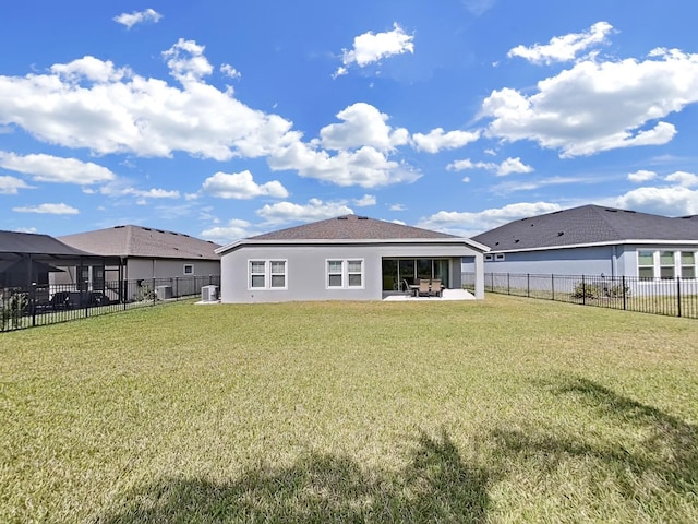 rear view of property with a yard, a patio, a fenced backyard, and stucco siding