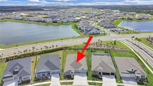 bird's eye view featuring a residential view and a water view