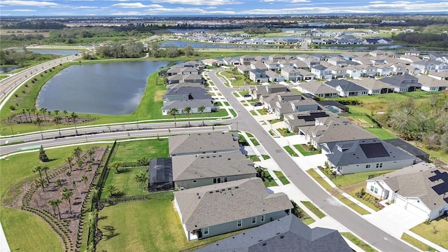 birds eye view of property featuring a water view and a residential view