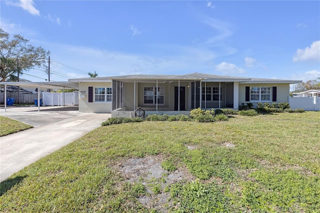 ranch-style house with fence, concrete driveway, and a front yard