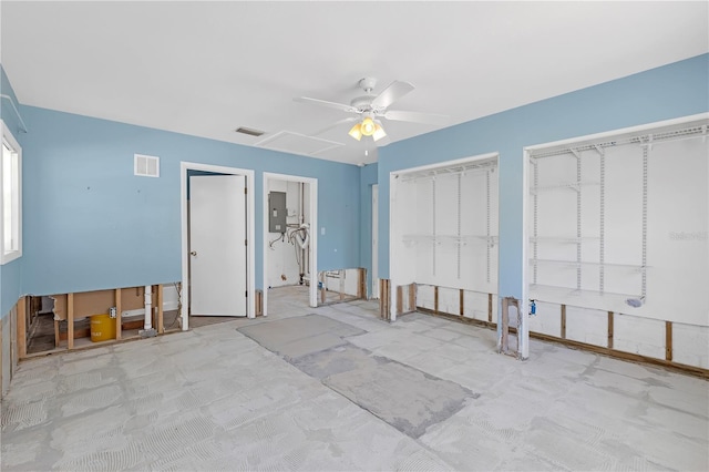 bedroom with attic access, two closets, visible vents, and electric panel