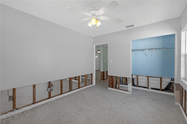 unfurnished bedroom with a ceiling fan, a closet, visible vents, and speckled floor