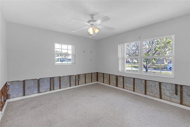 unfurnished room with a ceiling fan and speckled floor