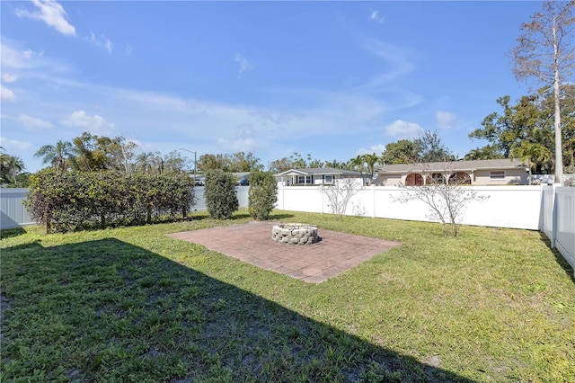 view of yard featuring a fire pit, a patio, and a fenced backyard