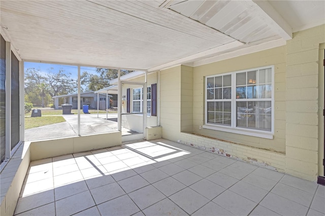 unfurnished sunroom with wooden ceiling