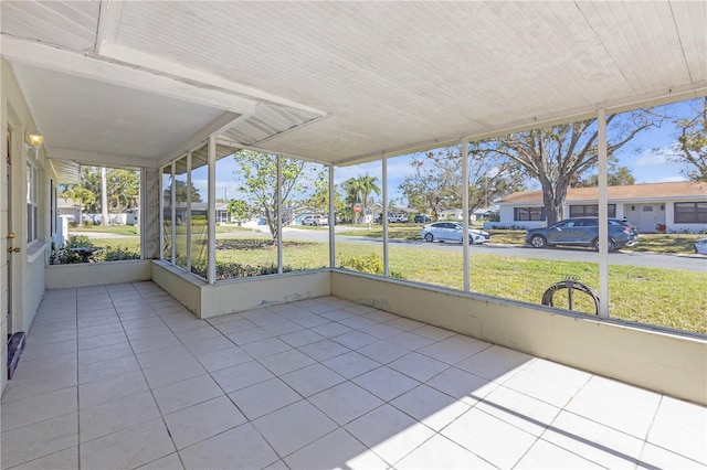 unfurnished sunroom with a residential view