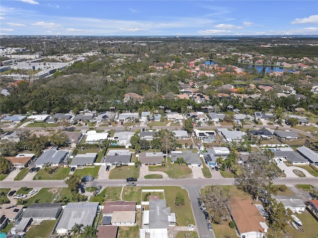 drone / aerial view featuring a water view and a residential view