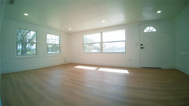 entryway featuring visible vents, baseboards, wood finished floors, and recessed lighting